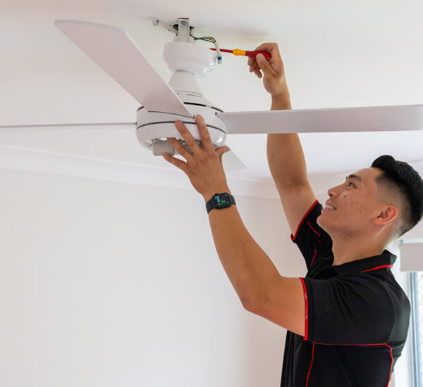 electrician installing a ceiling fan